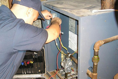 Plumber repairing oil burner