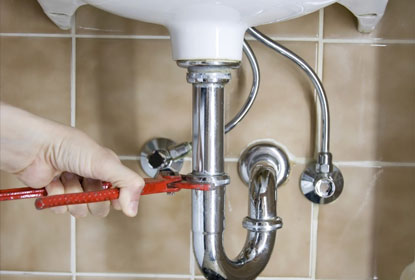 plumber working on taps